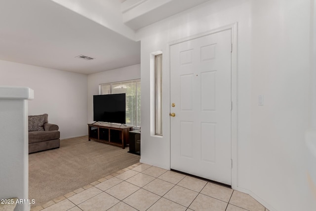 6276 N 75th Ln, Glendale, AZ 85303 - entryway with light colored carpet, light tile patterned flooring, and baseboards