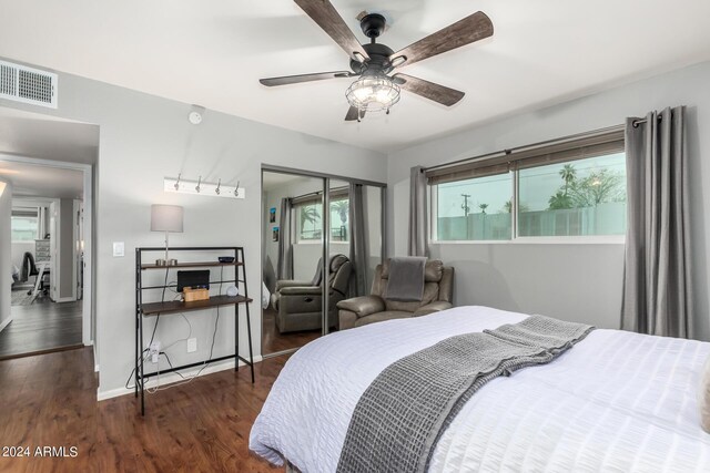 bedroom featuring a closet, ceiling fan, and dark hardwood / wood-style flooring