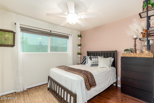 bedroom with dark hardwood / wood-style flooring and ceiling fan