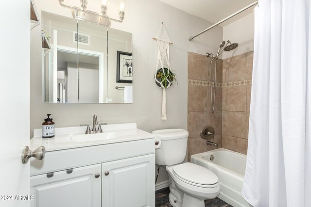 full bathroom with vanity, shower / bath combo with shower curtain, and toilet