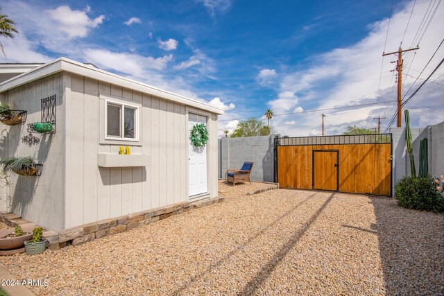 view of side of home featuring a storage unit