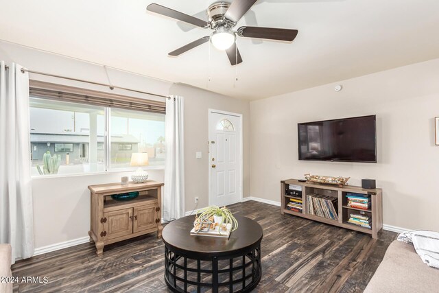 living room featuring ceiling fan and dark hardwood / wood-style flooring