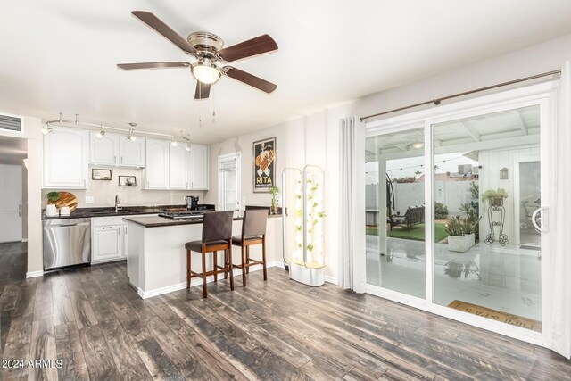 kitchen featuring white cabinets, kitchen peninsula, dishwasher, dark hardwood / wood-style flooring, and ceiling fan