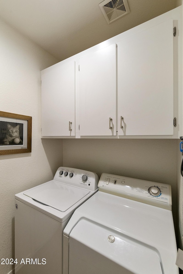 washroom with cabinets and separate washer and dryer