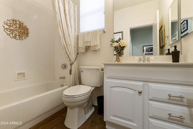 full bathroom featuring shower / bath combination with curtain, vanity, hardwood / wood-style flooring, and toilet