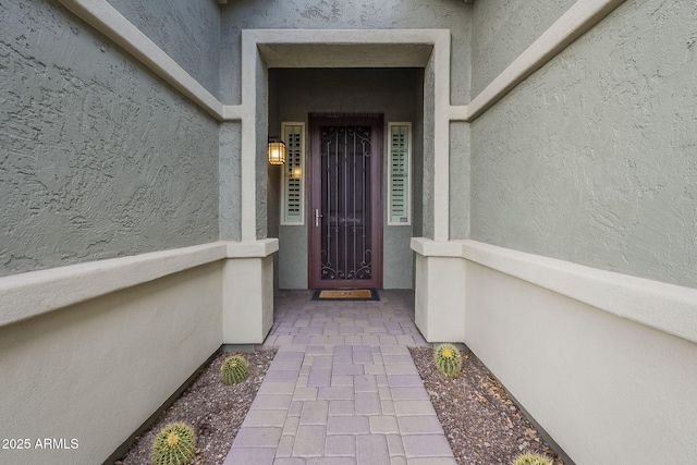 doorway to property with stucco siding