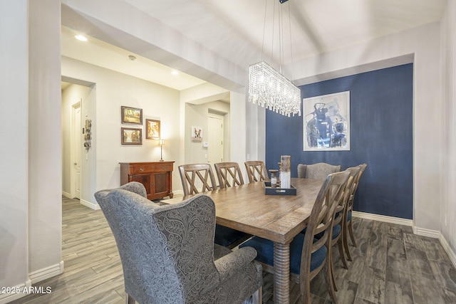 dining space with recessed lighting, a chandelier, baseboards, and wood finished floors