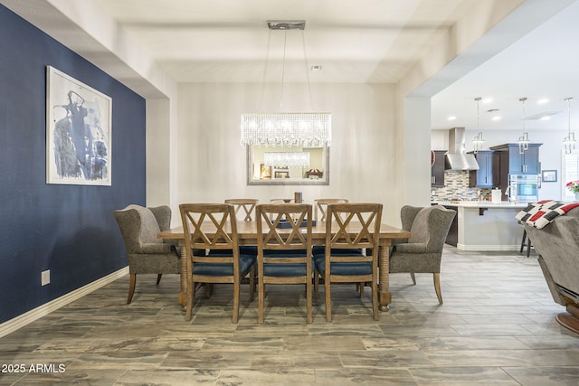 dining space with recessed lighting, wood finished floors, and baseboards