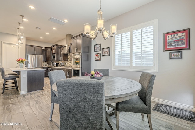 dining space featuring recessed lighting, visible vents, baseboards, and a chandelier