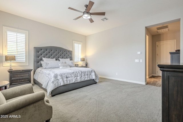 carpeted bedroom featuring visible vents, ceiling fan, and baseboards