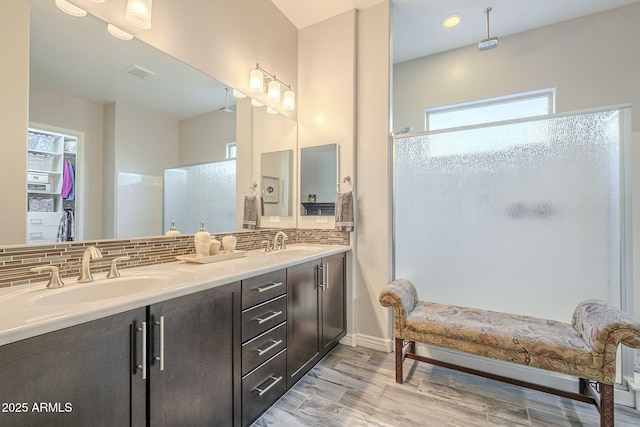 full bathroom featuring a shower stall, visible vents, a wealth of natural light, and a sink