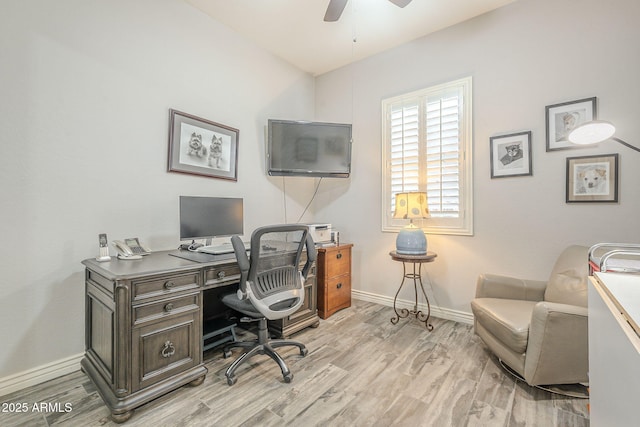 home office with baseboards, light wood-style floors, and a ceiling fan