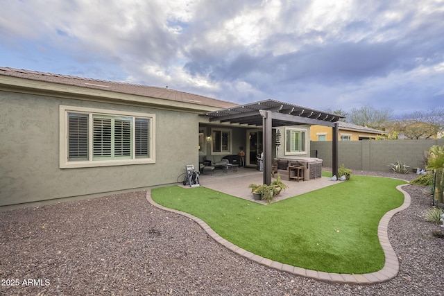 rear view of property featuring stucco siding, a patio, a fenced backyard, and a pergola