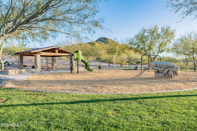 view of community with a gazebo, a yard, and a mountain view