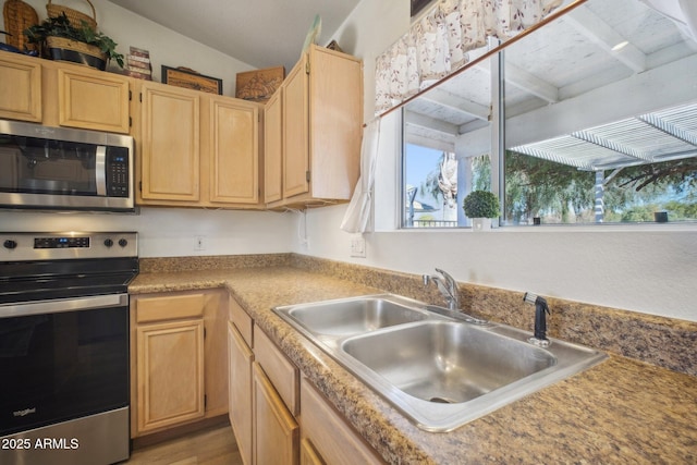 kitchen featuring sink, light brown cabinets, and appliances with stainless steel finishes