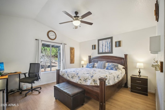 bedroom featuring ceiling fan, light hardwood / wood-style flooring, and lofted ceiling