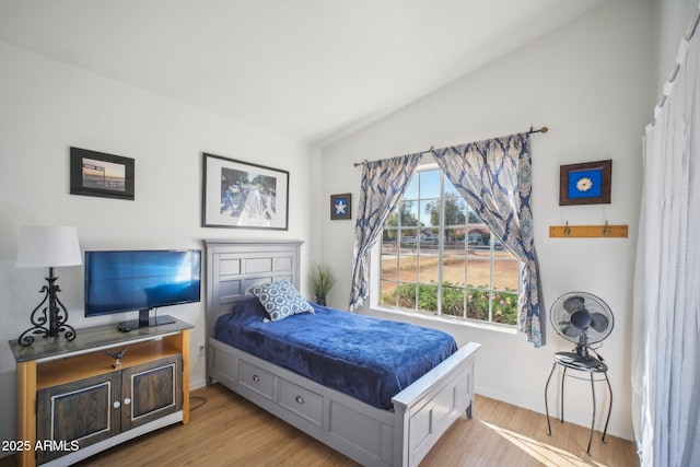 bedroom featuring light hardwood / wood-style flooring and vaulted ceiling