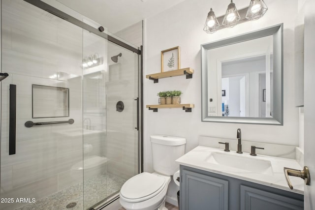 bathroom featuring vanity, toilet, and an enclosed shower