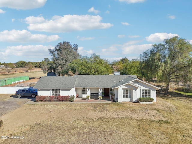 ranch-style house featuring a patio area and a front lawn