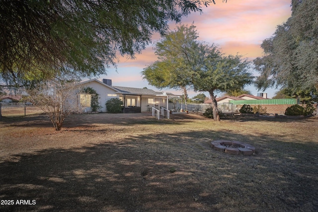 exterior space featuring a yard and a fire pit