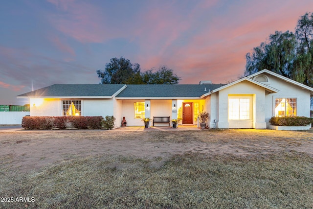 single story home featuring a lawn and a porch