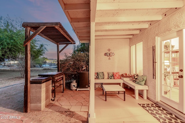 patio terrace at dusk featuring an outdoor hangout area