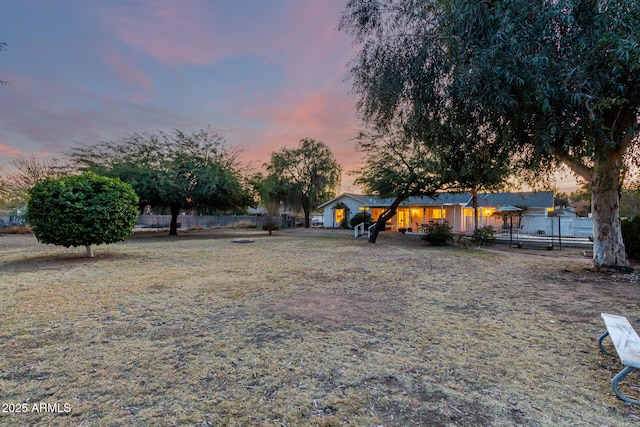 view of yard at dusk