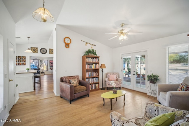 sitting room featuring light wood-type flooring, ceiling fan, french doors, and lofted ceiling