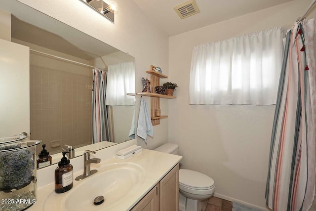 bathroom with vanity, toilet, a healthy amount of sunlight, and a shower with shower curtain