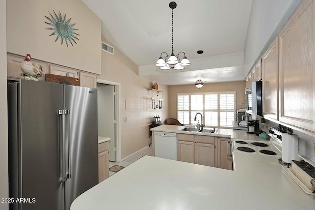 kitchen featuring sink, high quality fridge, kitchen peninsula, and white dishwasher