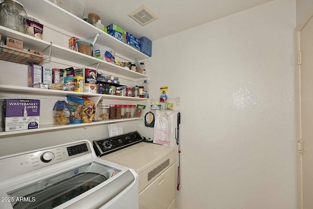 laundry area with independent washer and dryer