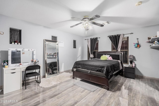 bedroom with hardwood / wood-style flooring and ceiling fan