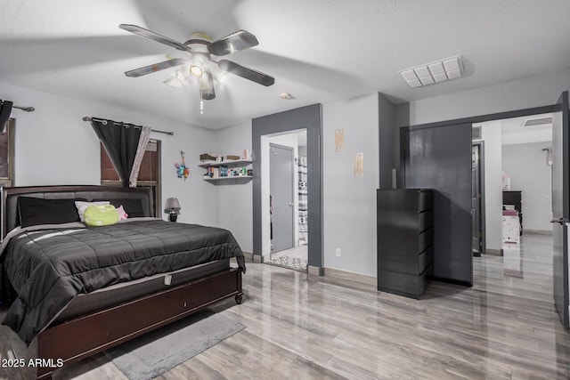 bedroom featuring light hardwood / wood-style flooring and ceiling fan