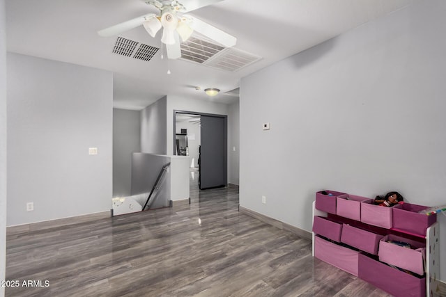 empty room with hardwood / wood-style flooring and ceiling fan