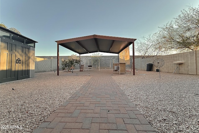 patio terrace at dusk featuring a gazebo