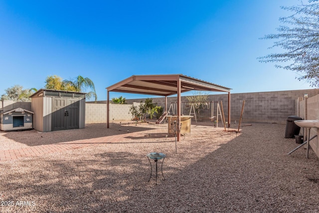 view of yard with a shed and a playground