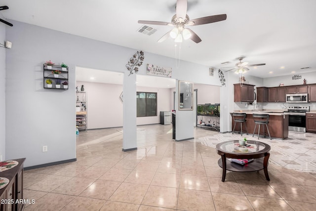 tiled living room featuring sink and ceiling fan