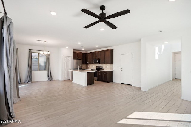 kitchen with decorative light fixtures, light hardwood / wood-style floors, ceiling fan with notable chandelier, and appliances with stainless steel finishes