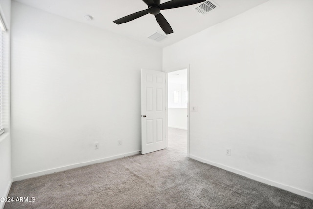 spare room featuring light carpet and ceiling fan