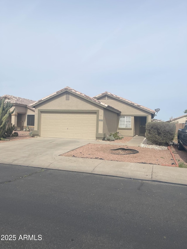 12034 W Aster Dr, El Mirage, AZ 85335 - single story home with a garage, stucco siding, driveway, and a tiled roof