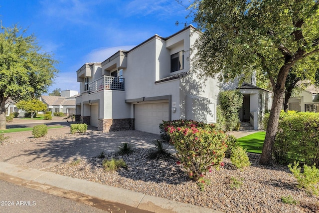 view of front of home featuring a balcony and a garage