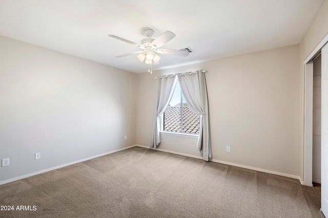 spare room featuring carpet flooring and ceiling fan