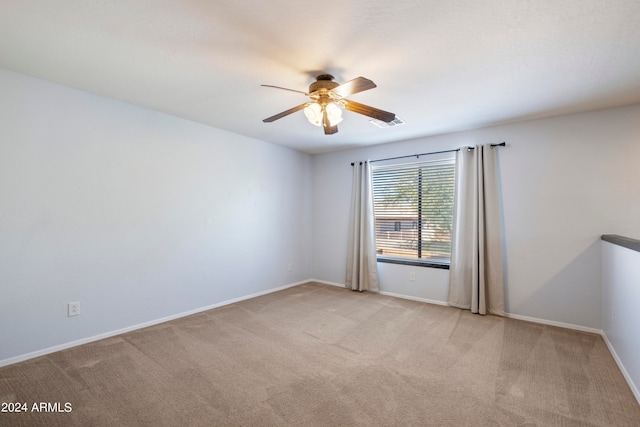 carpeted empty room featuring ceiling fan