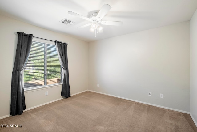 unfurnished room featuring light carpet and ceiling fan