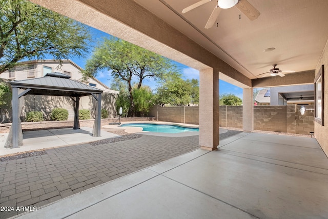 view of patio featuring a gazebo, ceiling fan, and a fenced in pool