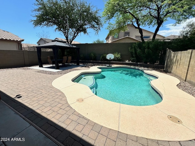 view of swimming pool with a gazebo and a patio area