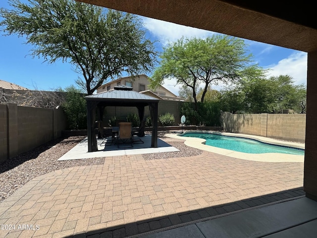 view of swimming pool with a gazebo and a patio area