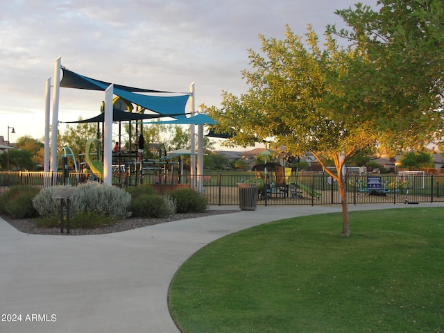 view of home's community with a playground and a yard