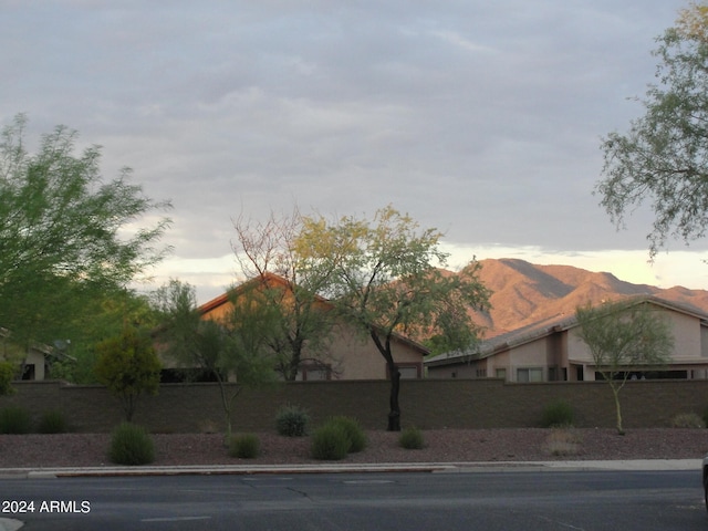 property exterior at dusk featuring a mountain view