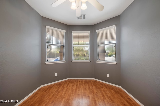 empty room featuring wood-type flooring and ceiling fan